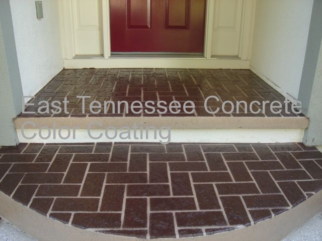 A walkway in front of a red door