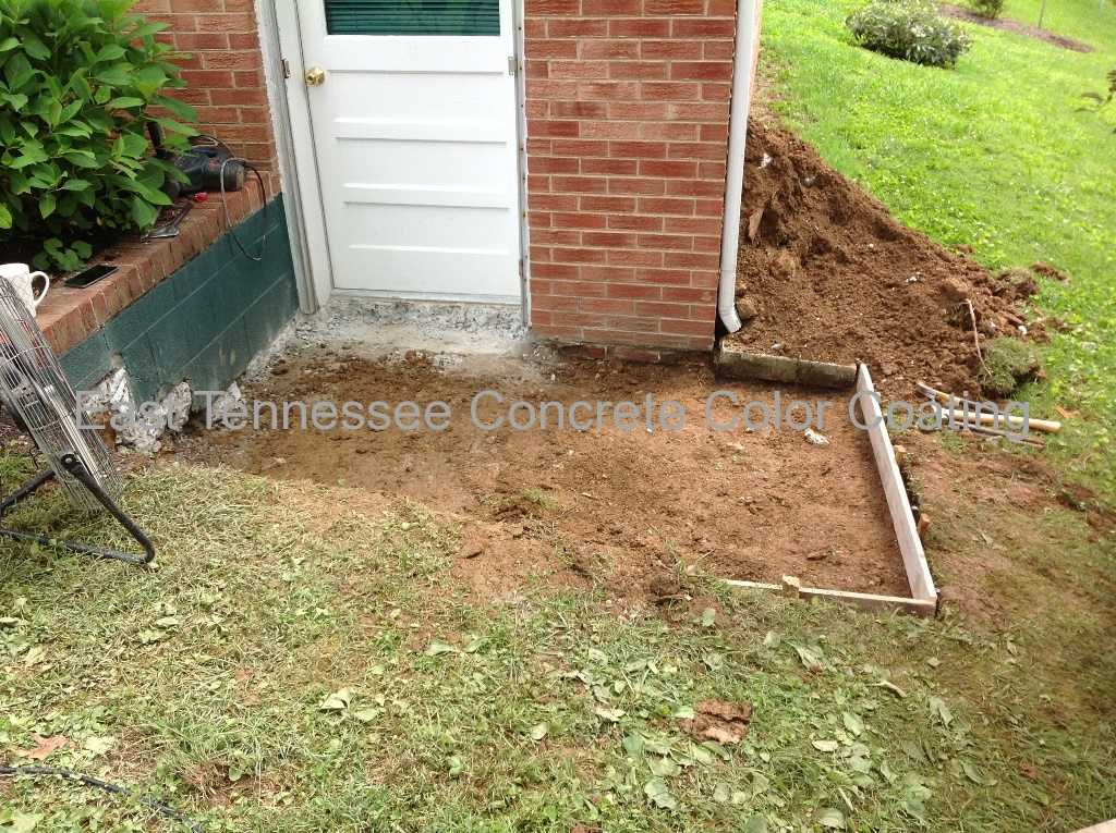 A brick building with a white door is being remodeled.