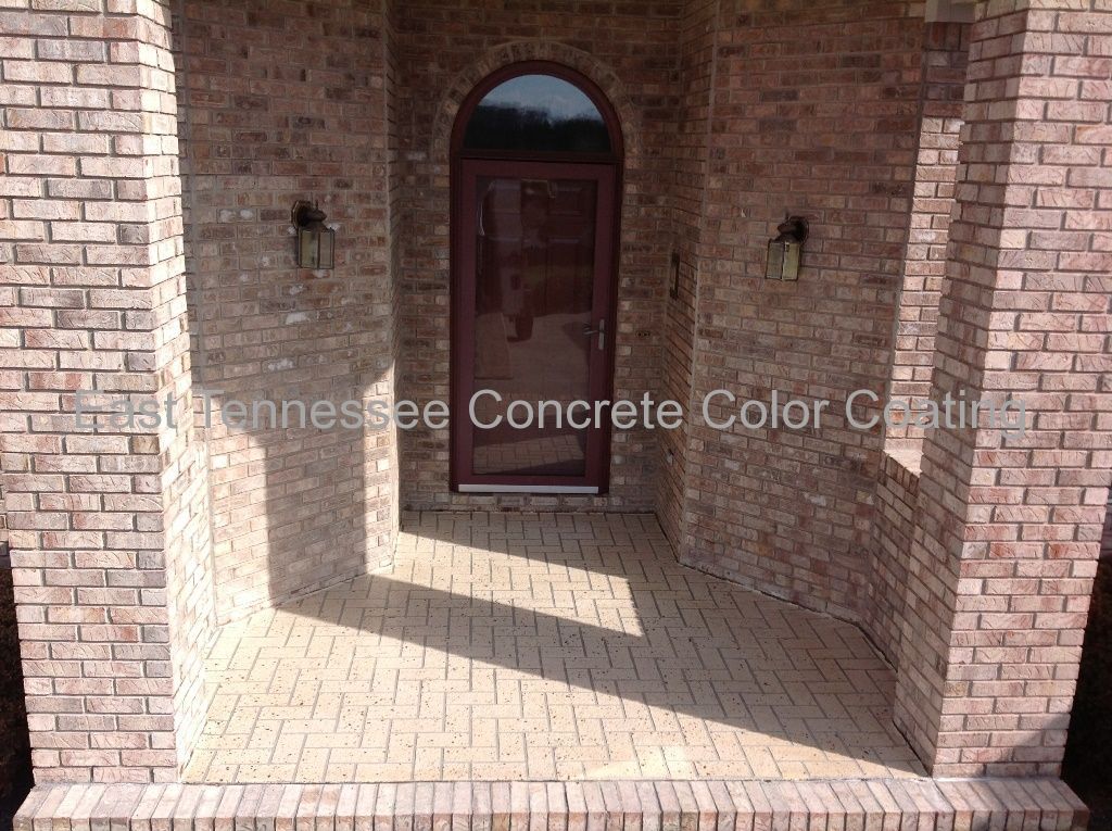 A brick building with a concrete porch and a door