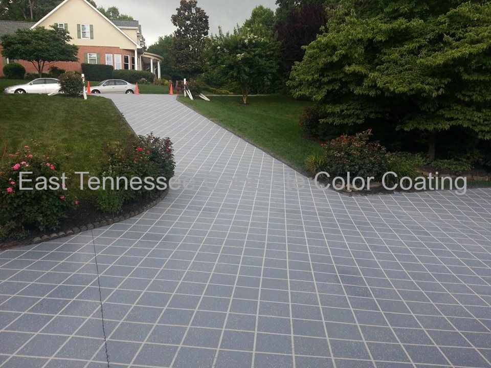 A concrete driveway with a checkered pattern