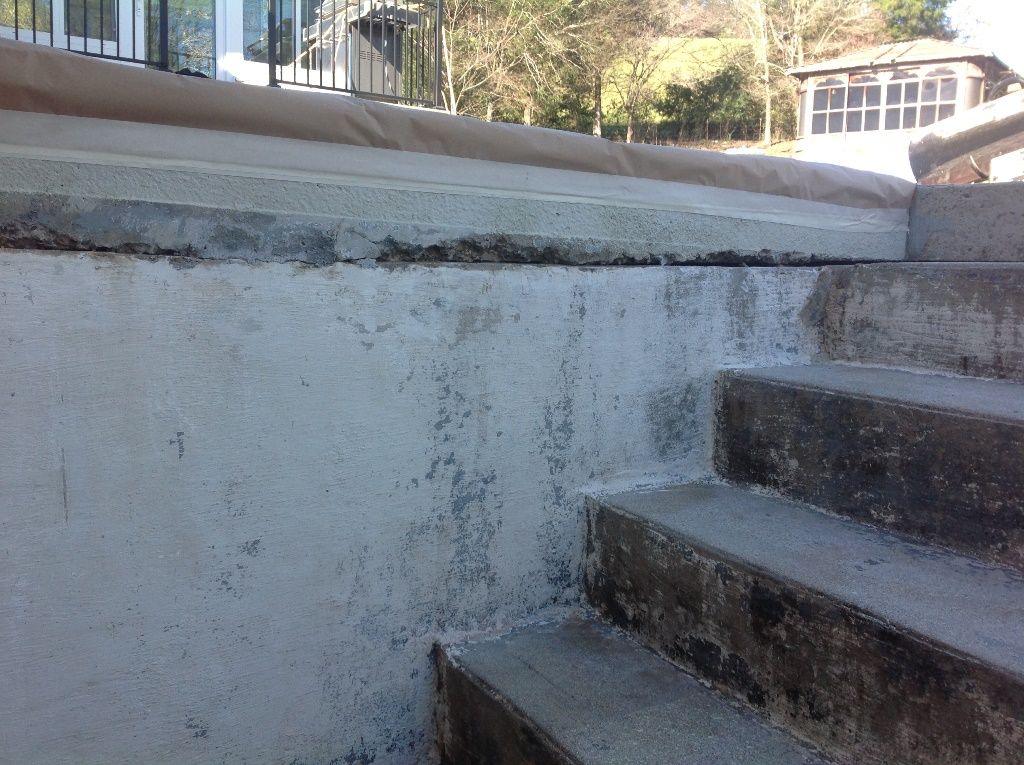 A concrete wall with stairs leading up to it.