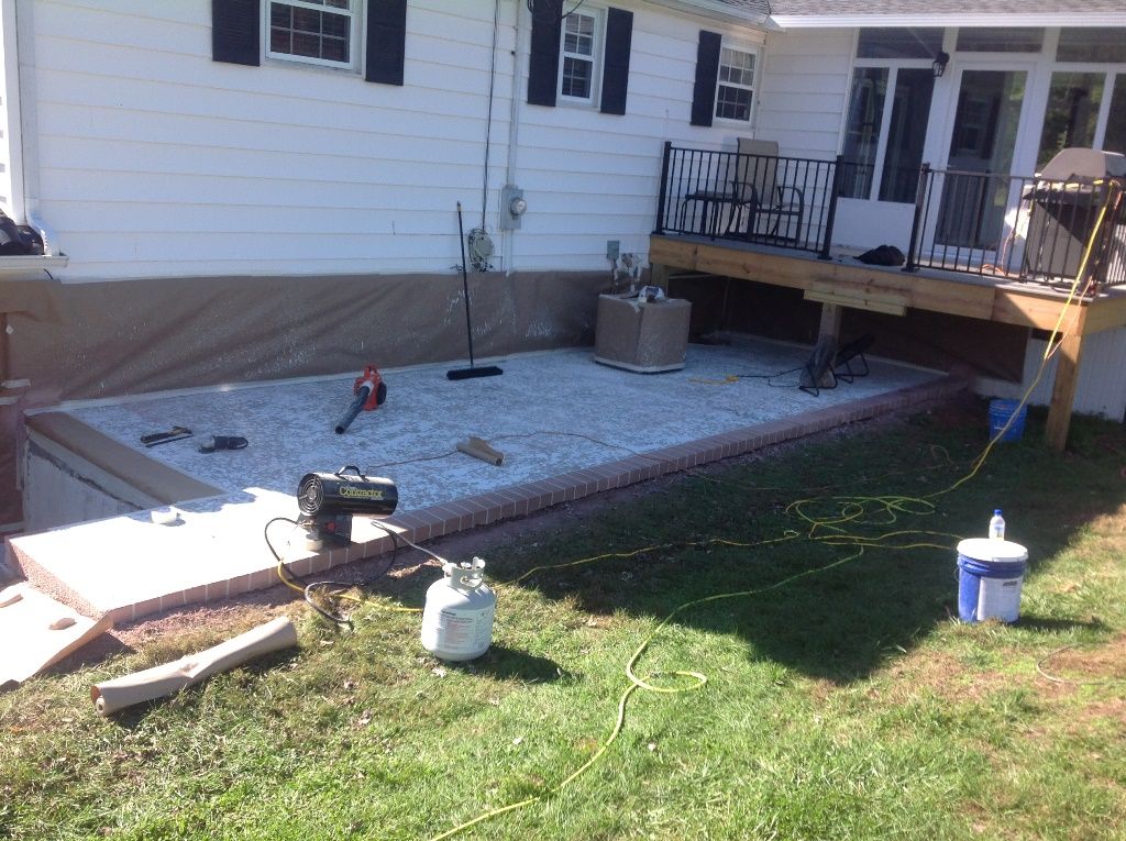 A house with a deck is being built in the backyard.