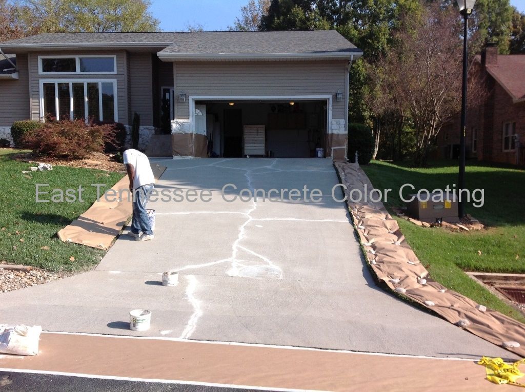 A concrete driveway leading to a house.