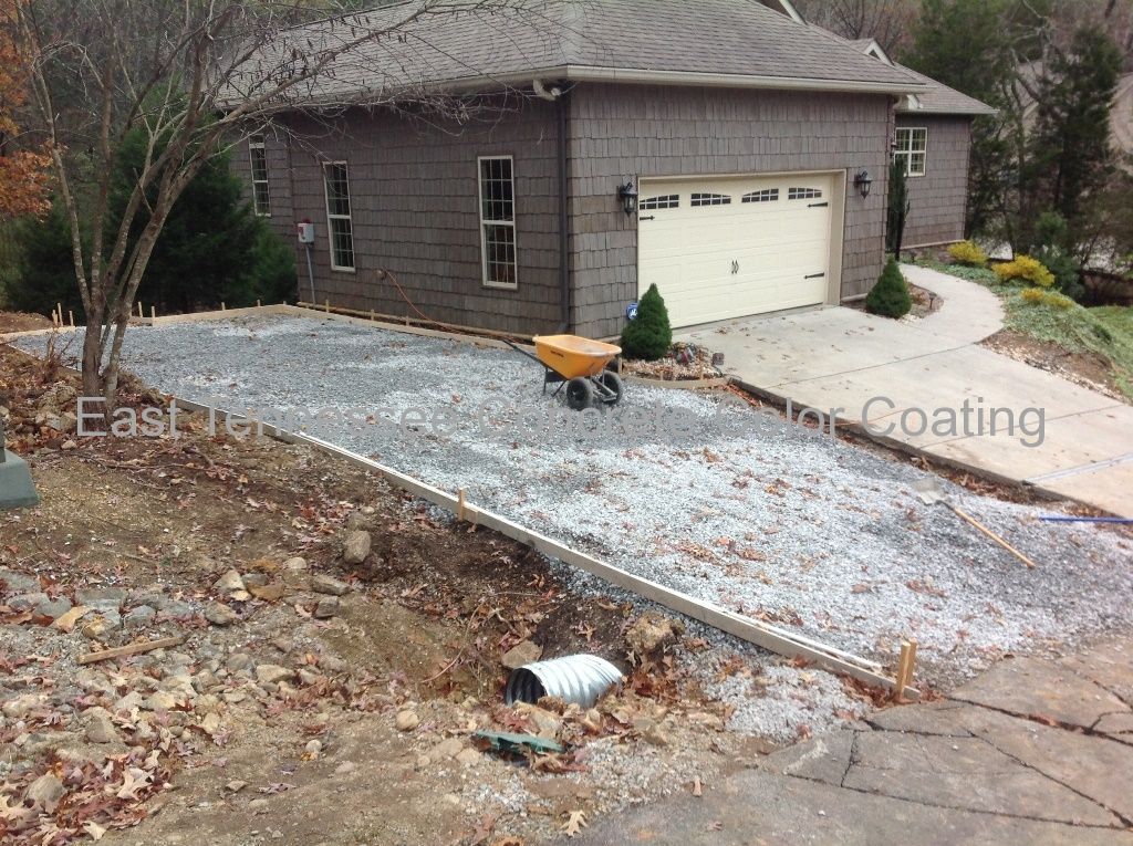 A house with a white garage door and a wheelbarrow in front of it