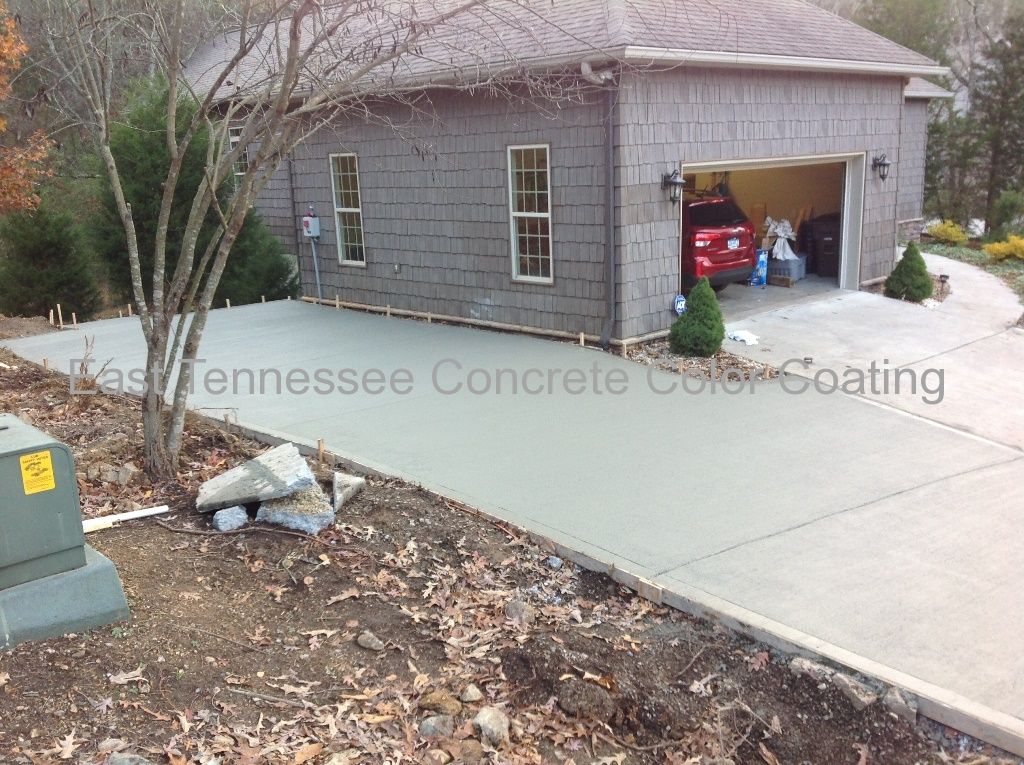 A concrete driveway in front of a house