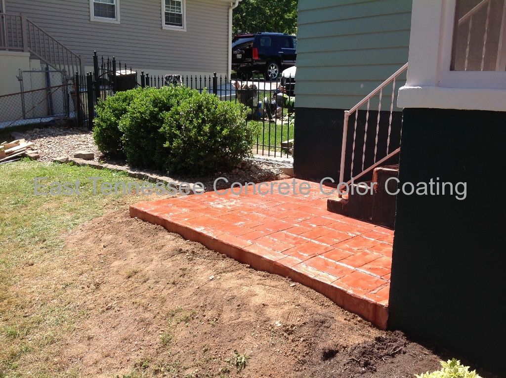 A house with a concrete walkway in front of it