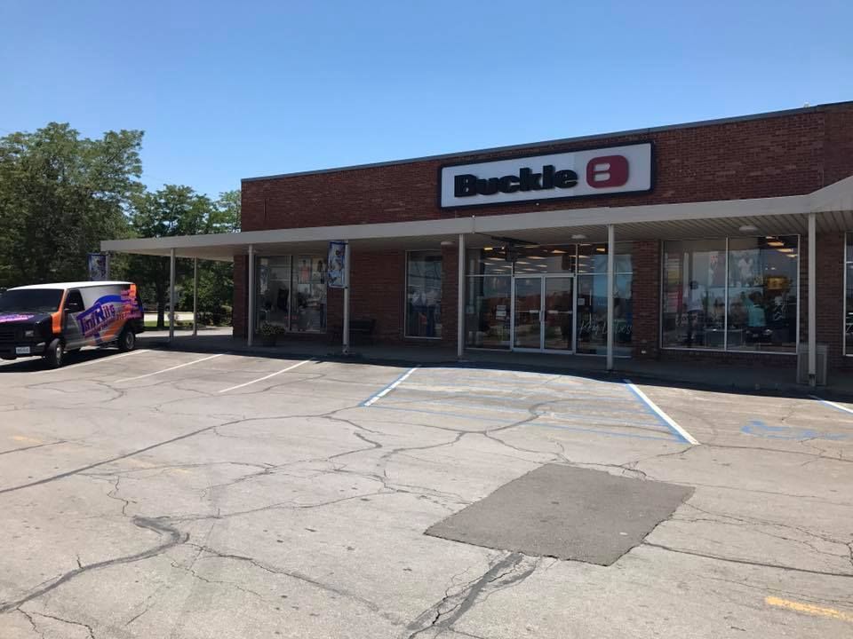 A truck is parked in front of a buckle store