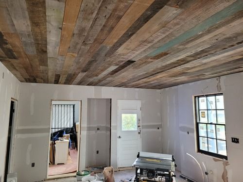 A room with a wooden ceiling and a table in it.