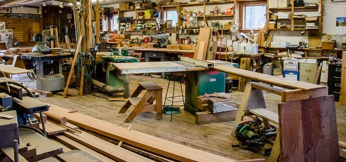 A woodworking shop filled with lots of wood and tools.