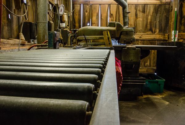A machine is sitting on a conveyor belt in a factory.