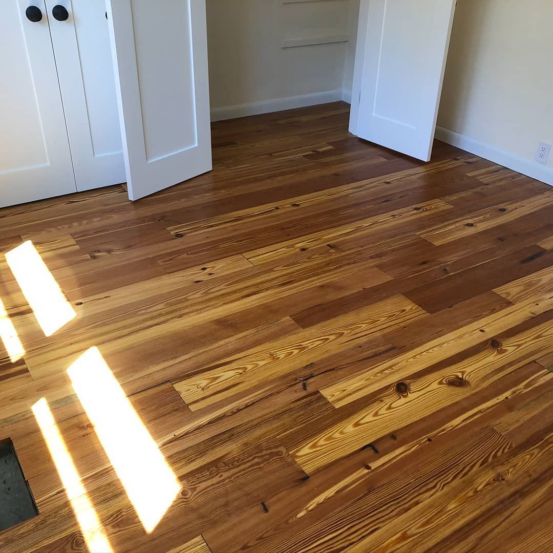 A room with hardwood floors and white doors.