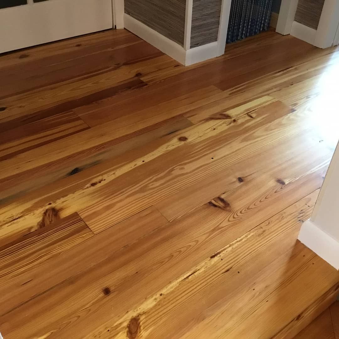 A close up of a wooden floor in a room.