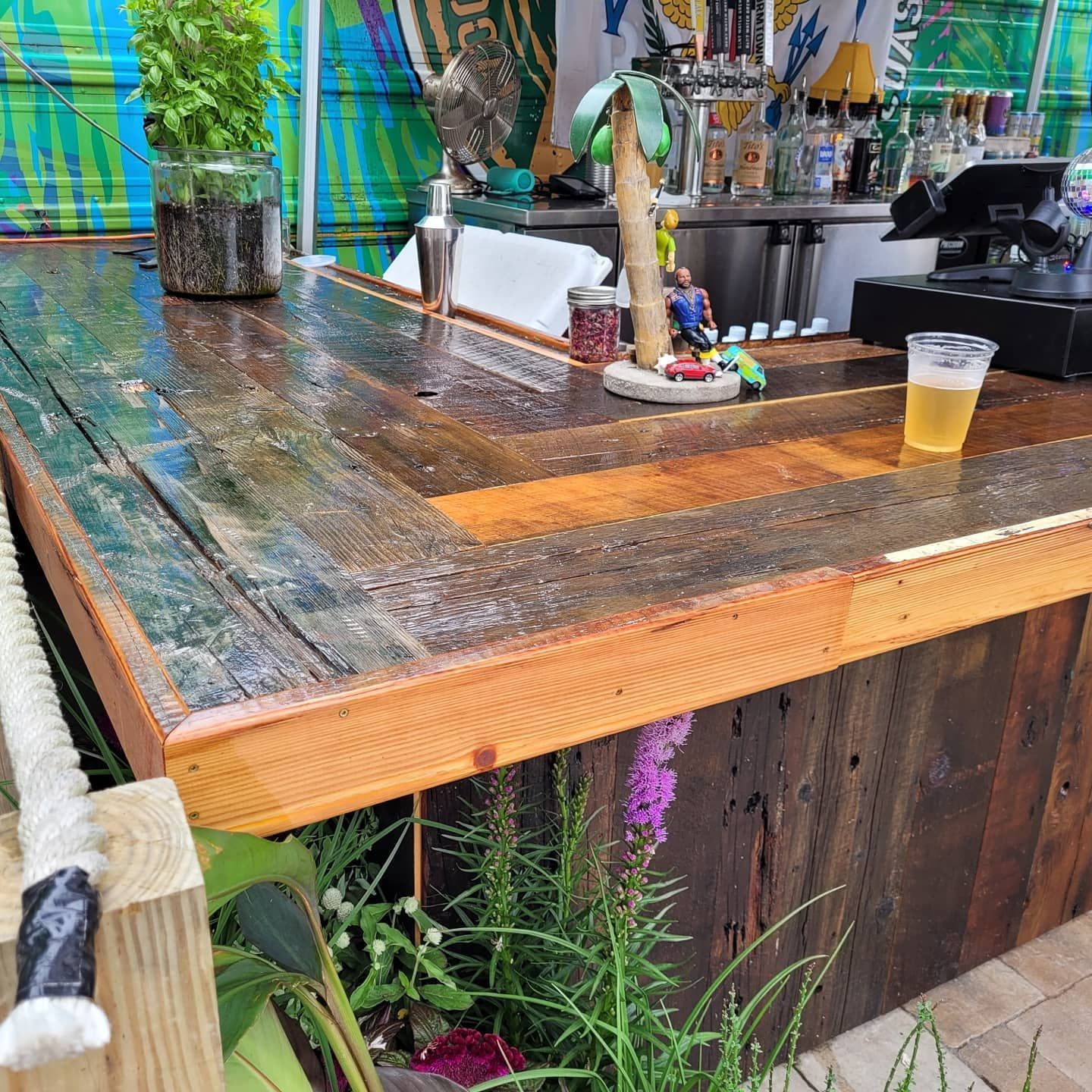 A wooden bar with a cup of beer on it