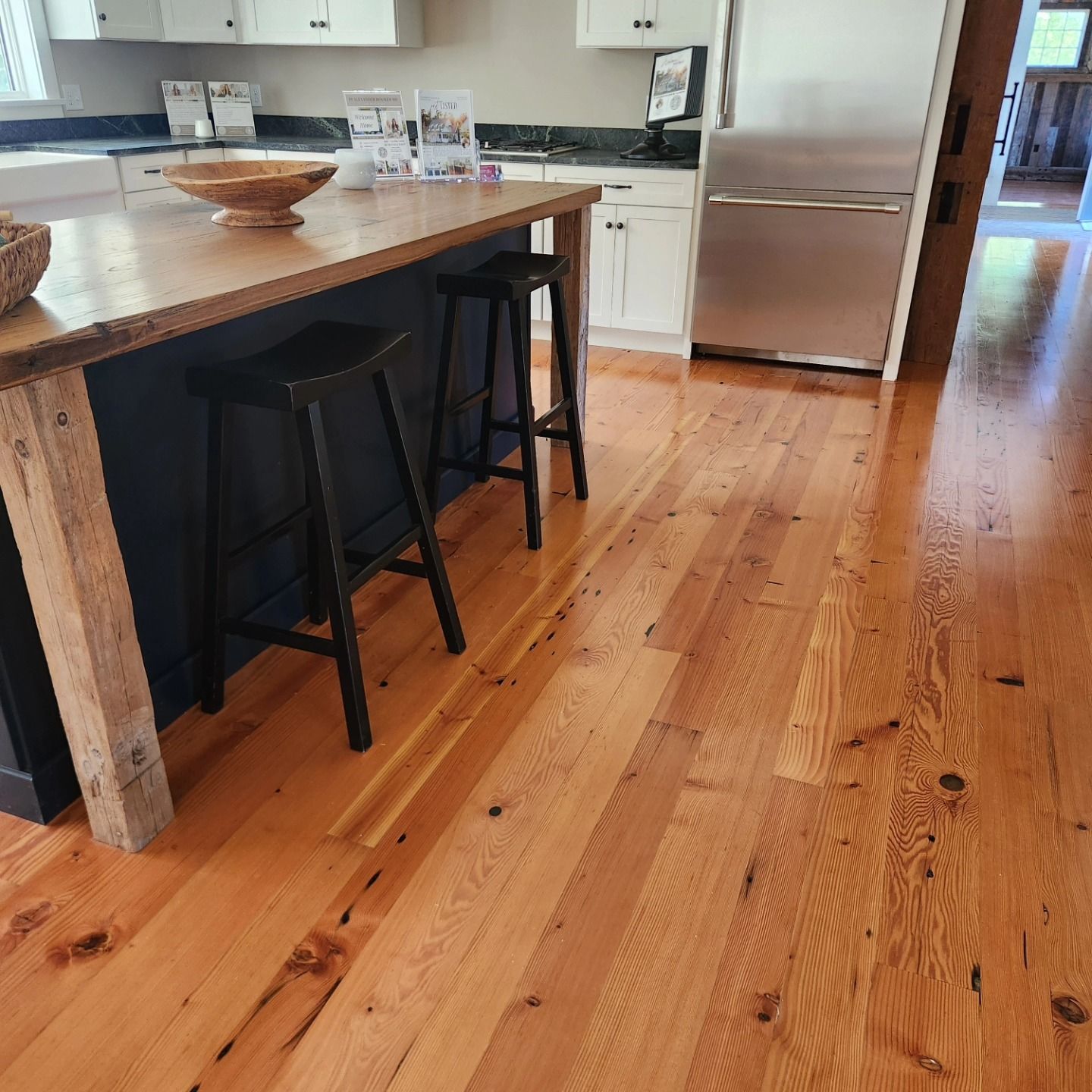 A kitchen with hardwood floors and a wooden table