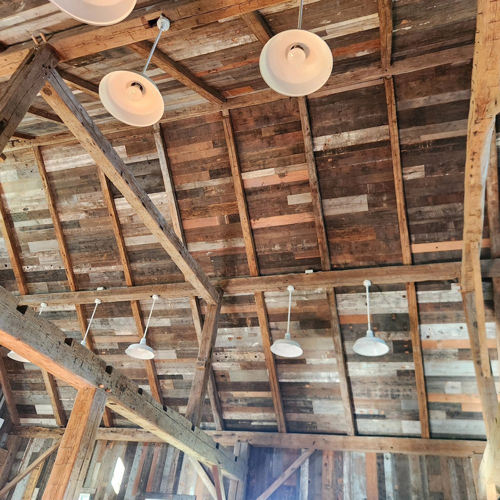 A wooden ceiling with a lot of lights hanging from it