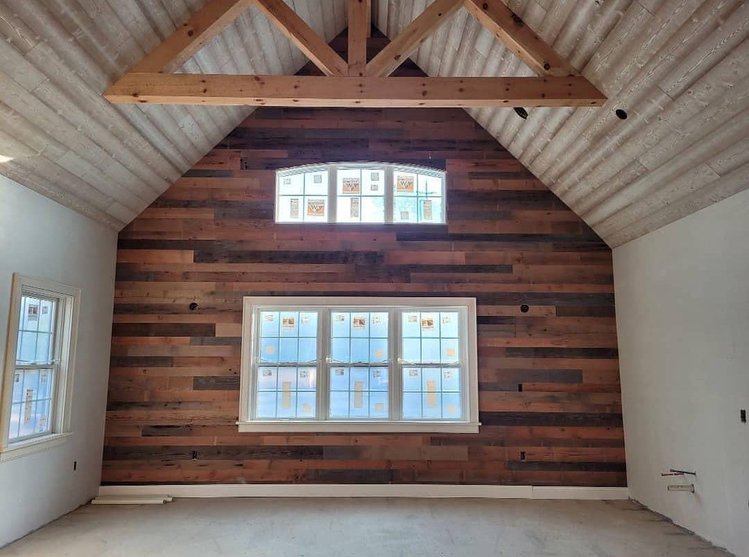 An empty room with a wooden wall and a window.
