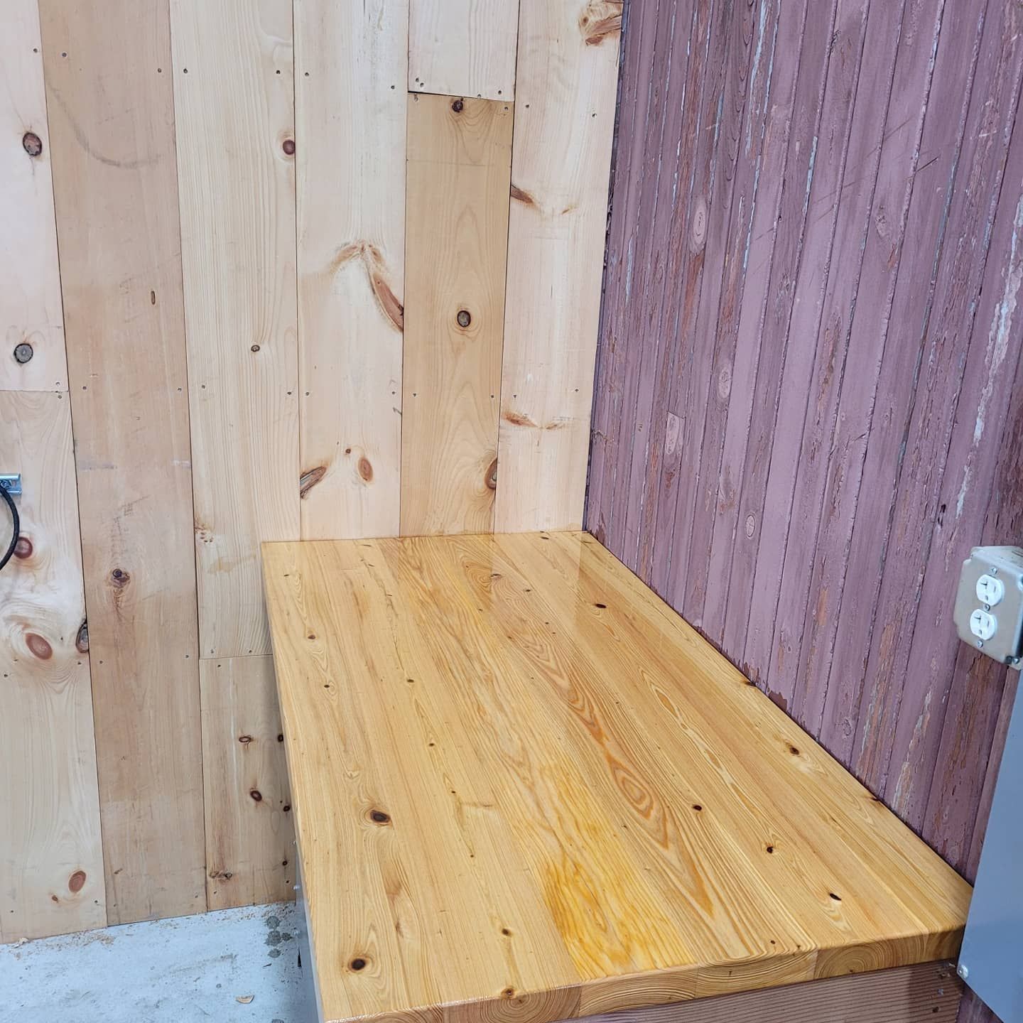 A wooden table in a corner of a room