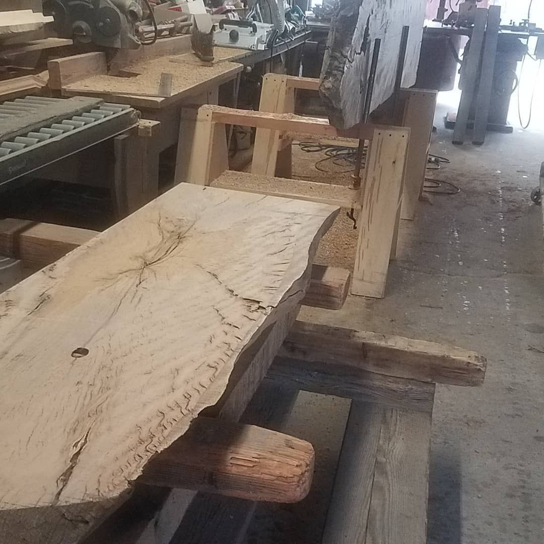 A large piece of wood is sitting on top of a table in a workshop.