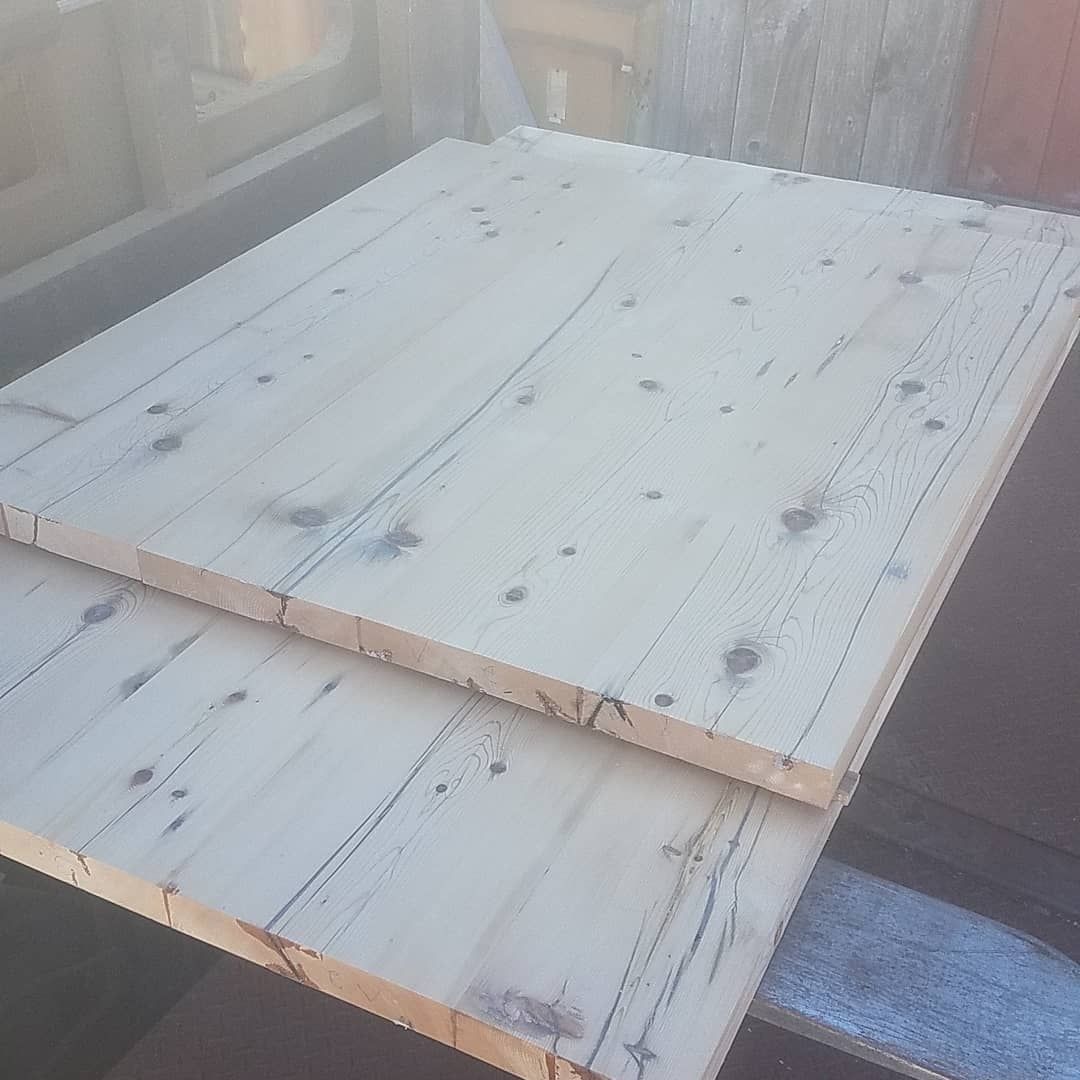 Two pieces of wood are stacked on top of each other on a table.