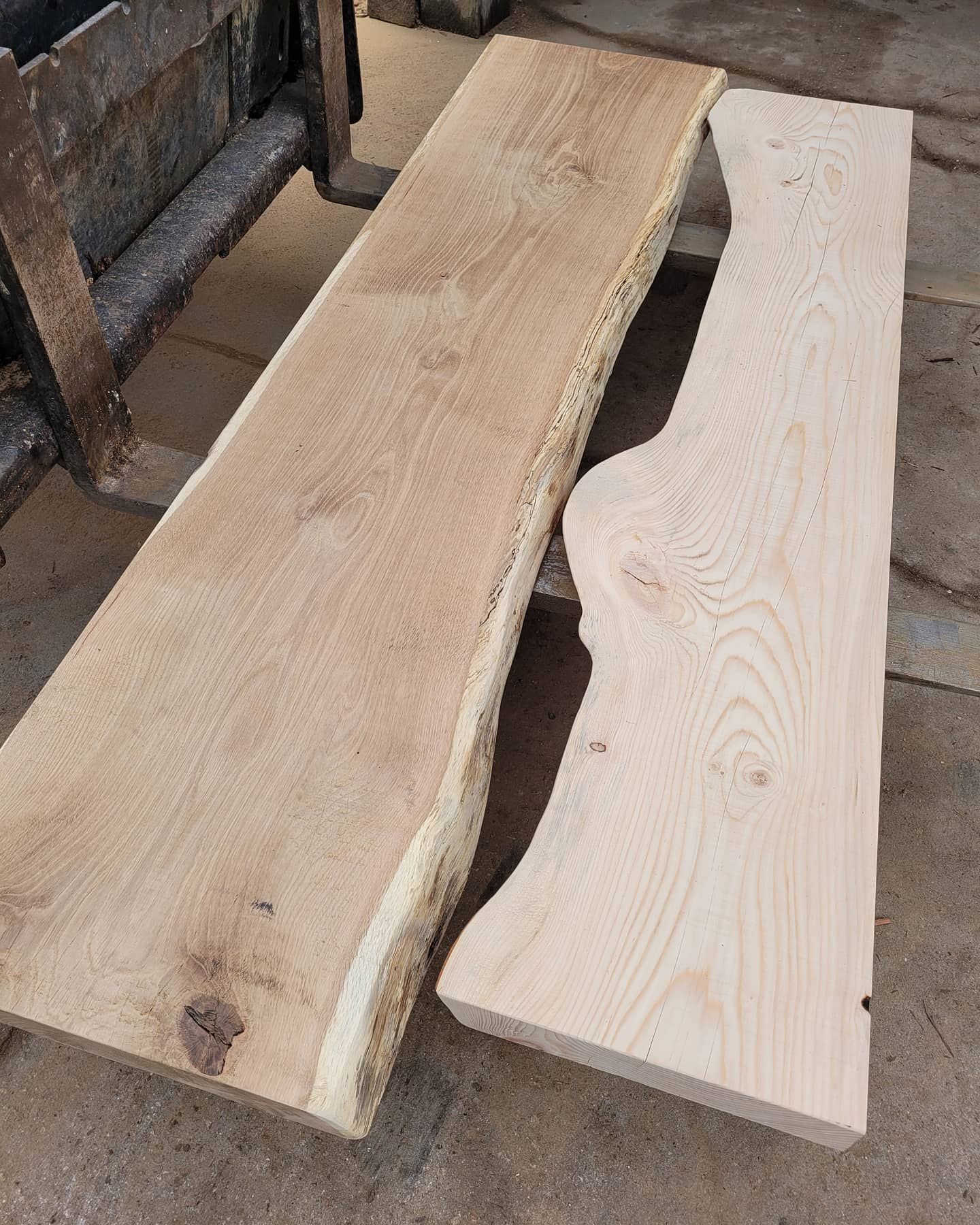 Two pieces of wood are sitting next to each other on the ground.