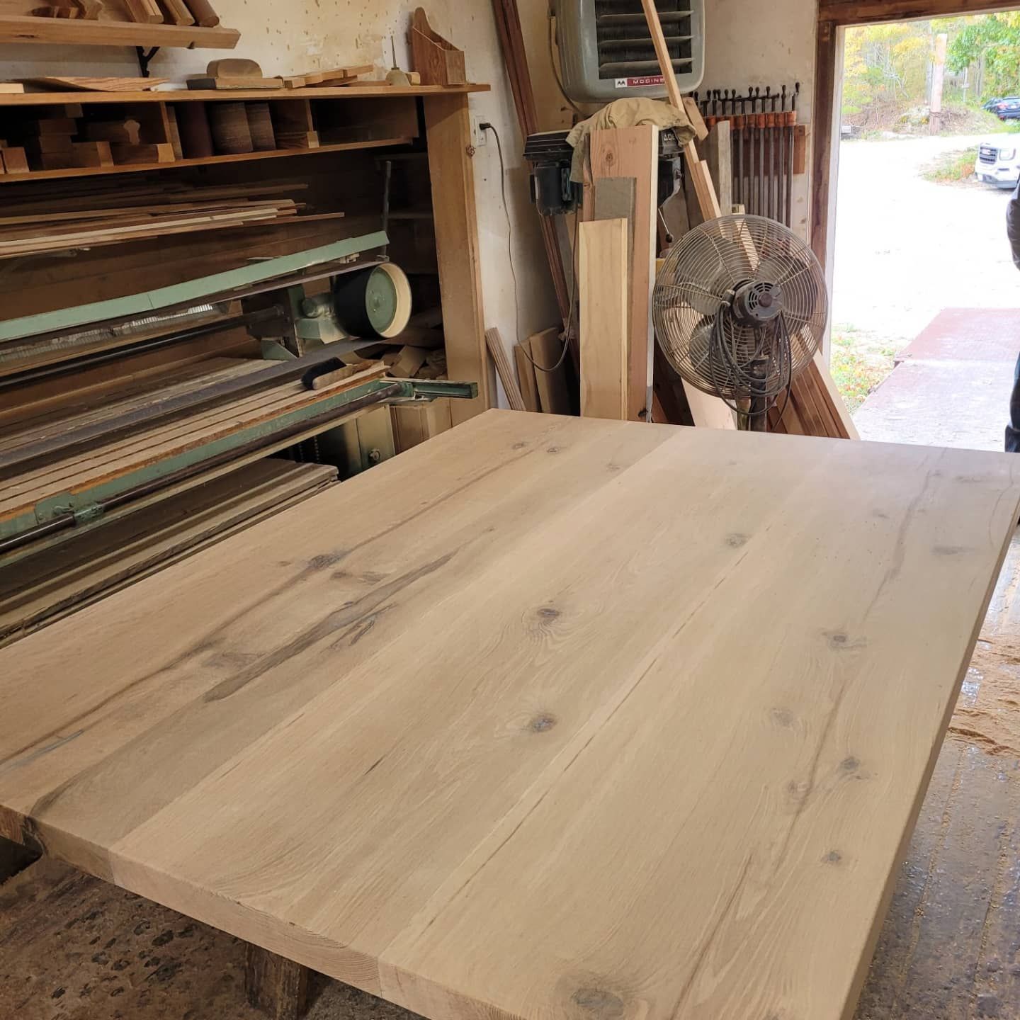 A large wooden table in a woodworking shop