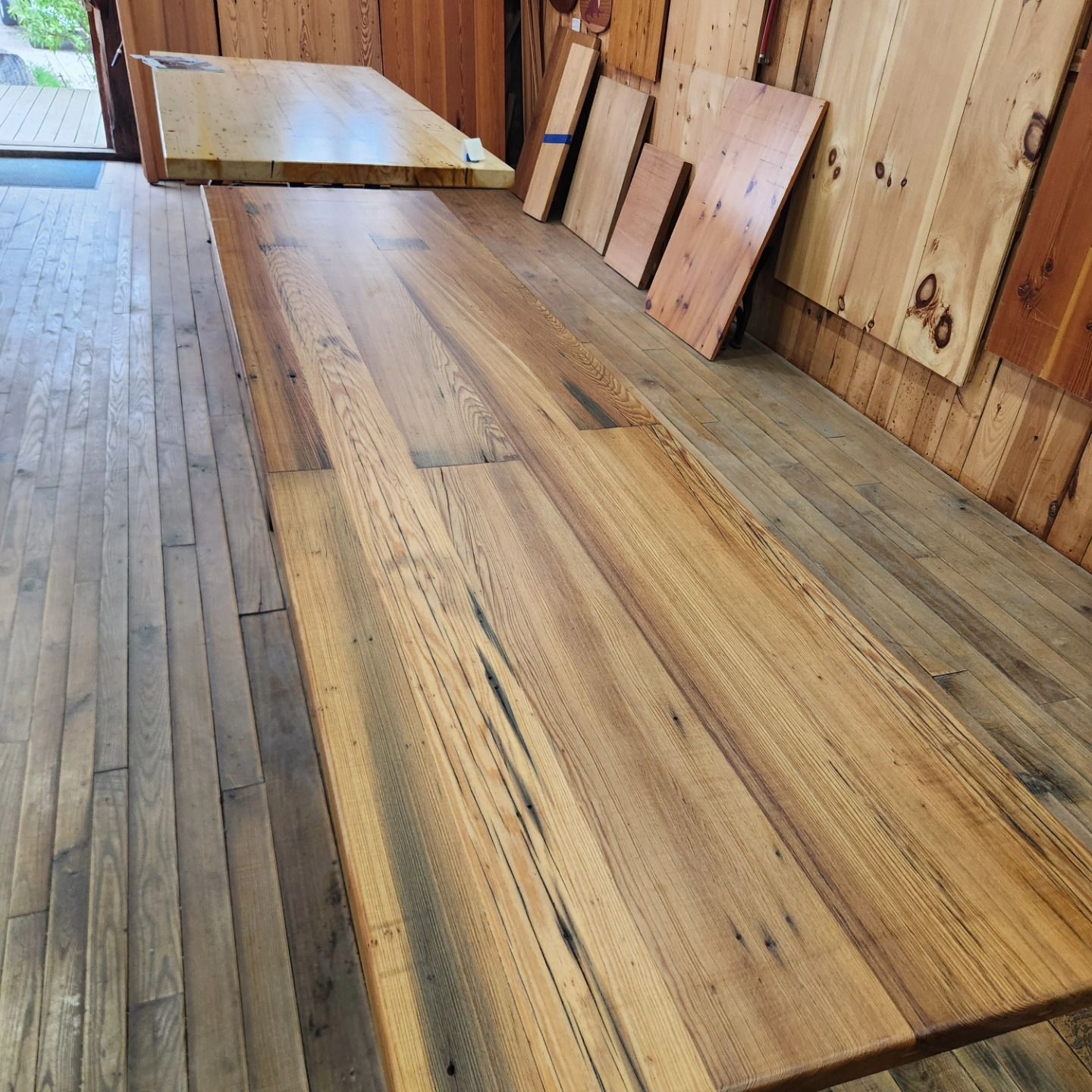 A wooden table is sitting on a wooden floor