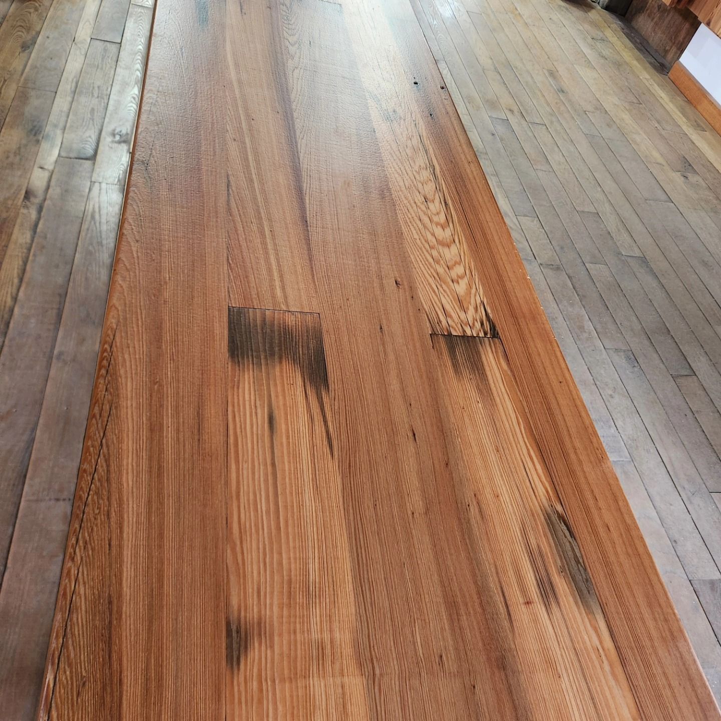 A wooden table with a wooden floor in the background