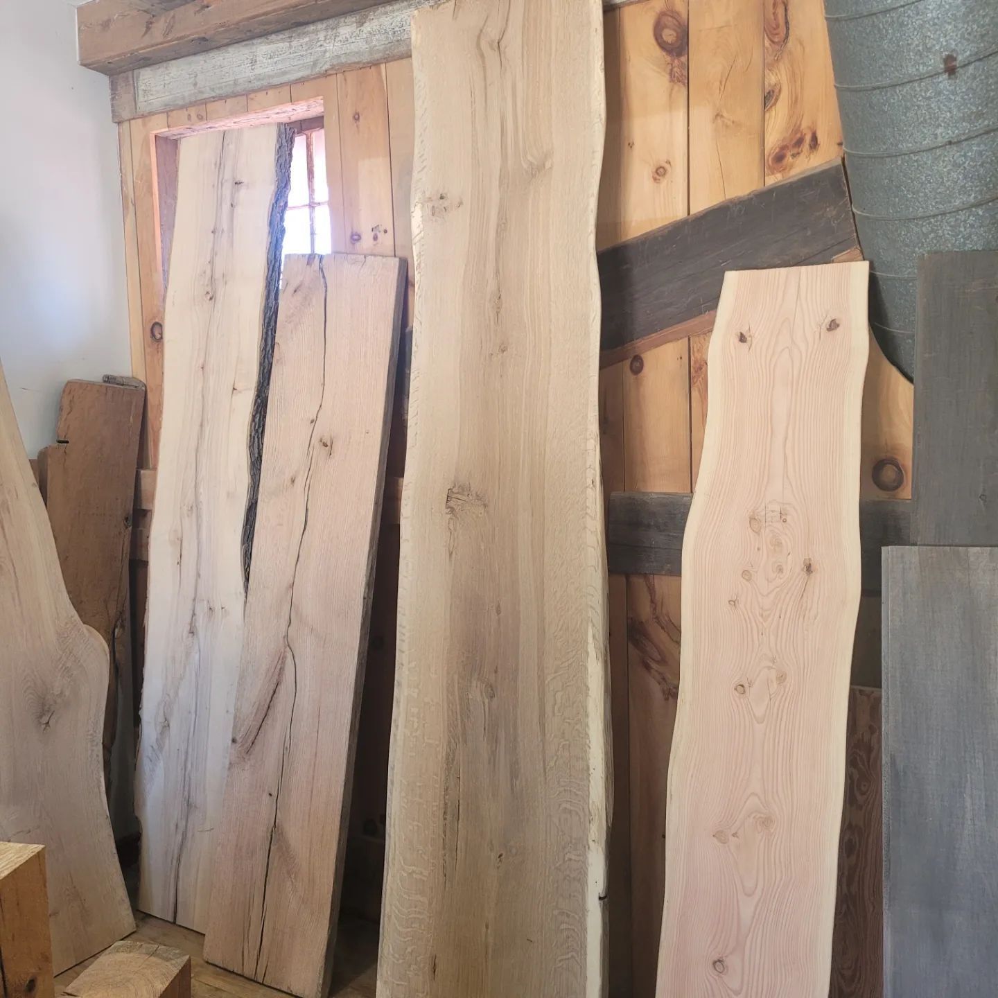 Several pieces of wood are stacked on top of each other in a room