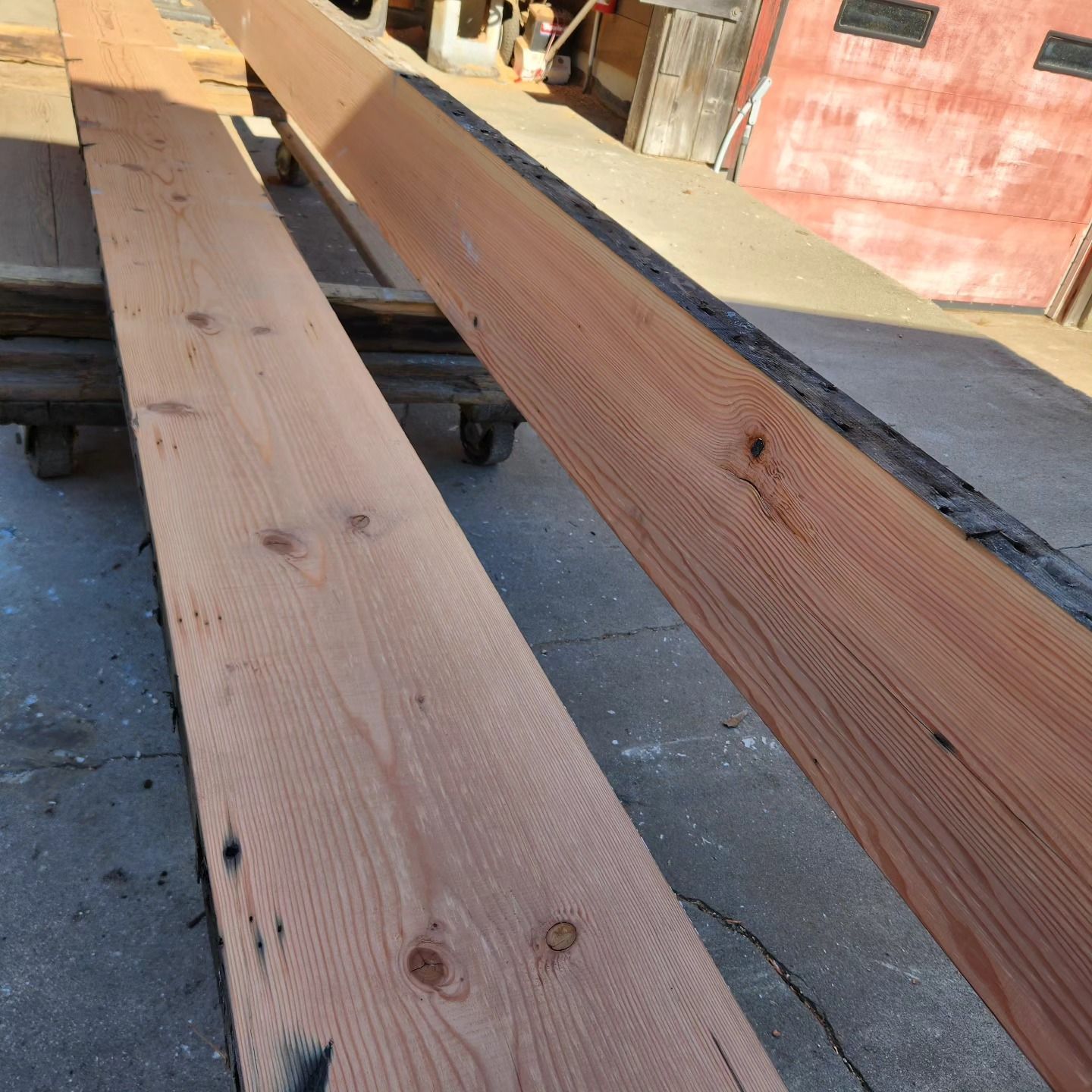 A bunch of wooden boards are sitting on the ground