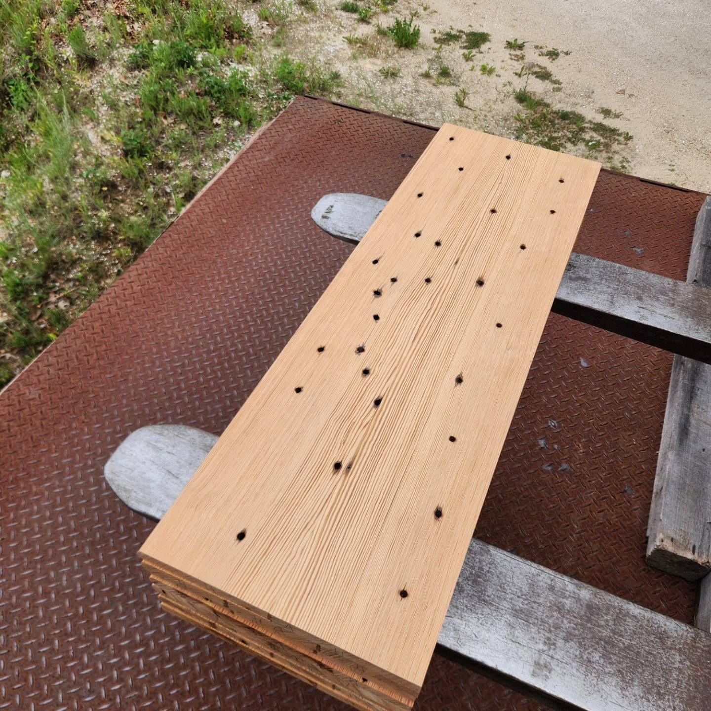 A piece of wood sitting on top of a metal surface