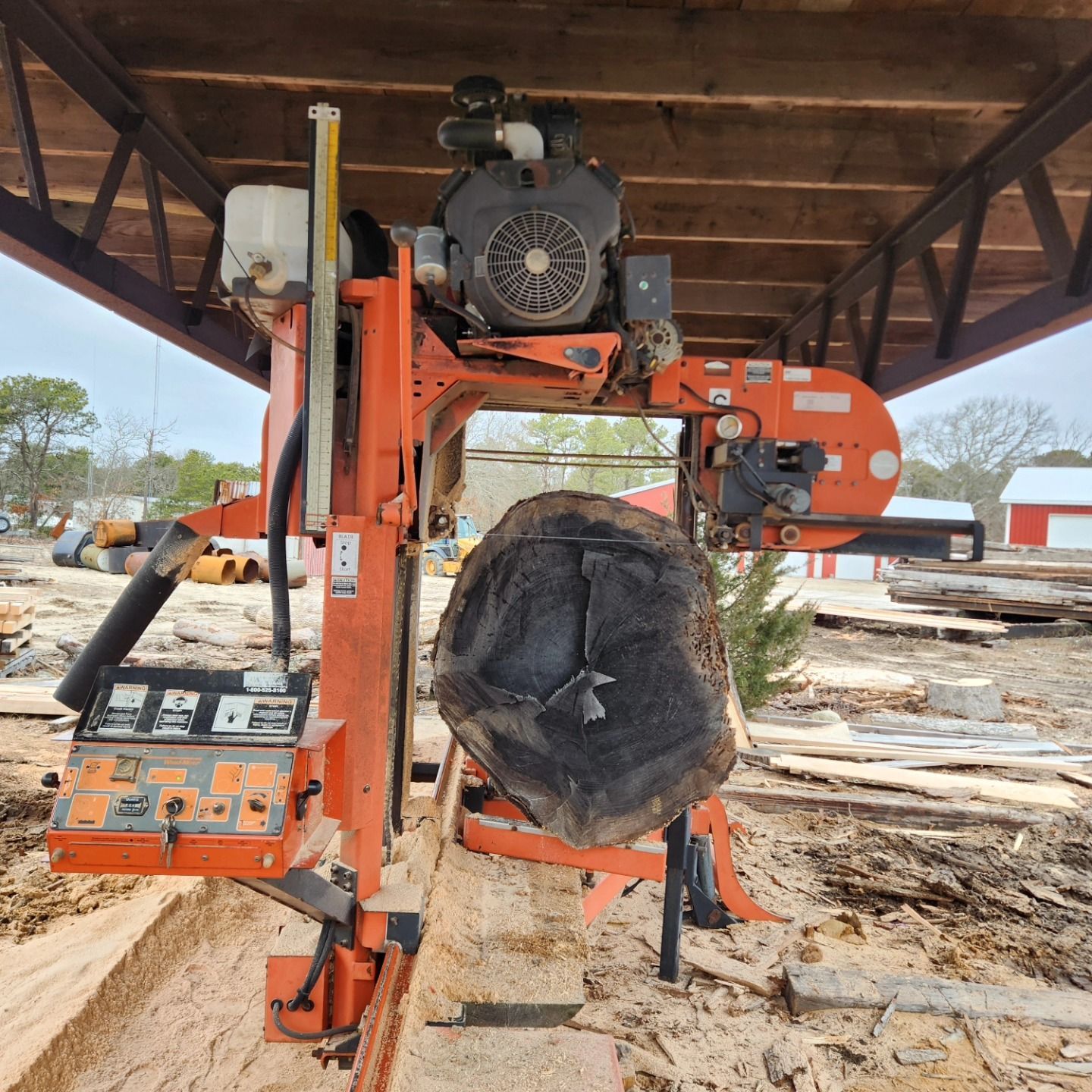 A large piece of wood is being cut by a machine