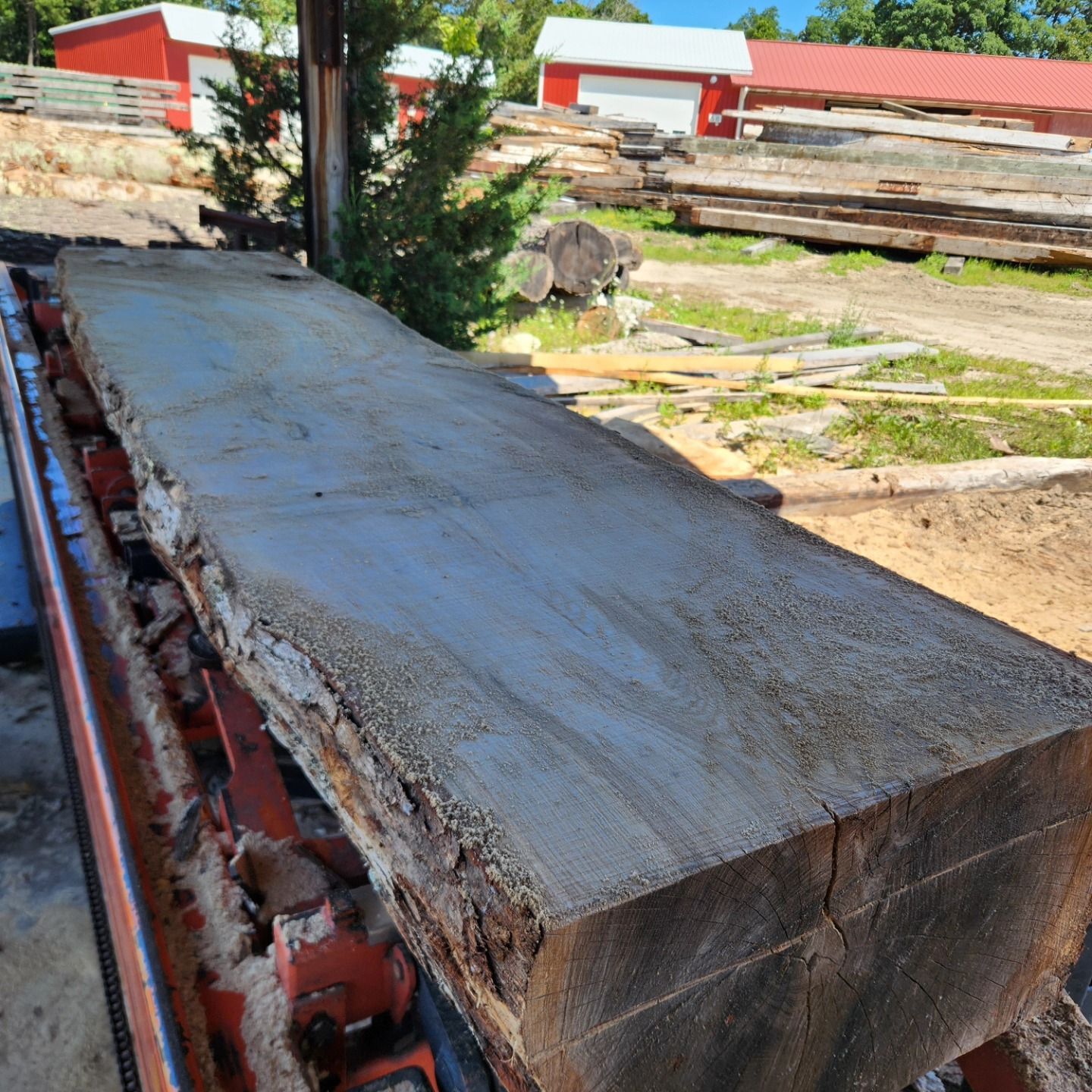 A large piece of wood is sitting on top of a conveyor belt.