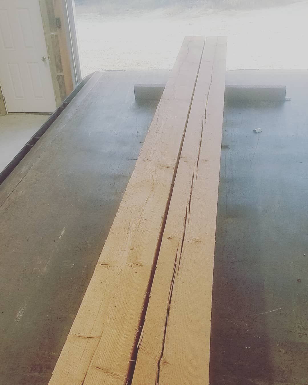 A long piece of wood is sitting on a table.