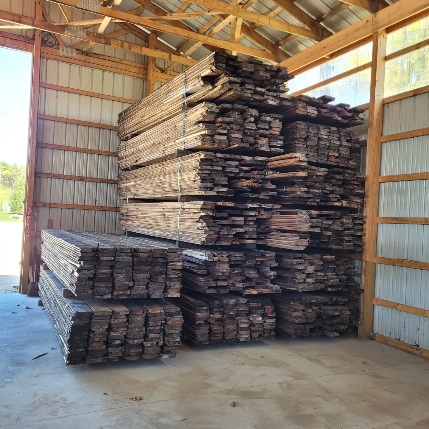 A warehouse filled with lots of wooden boards stacked on top of each other.