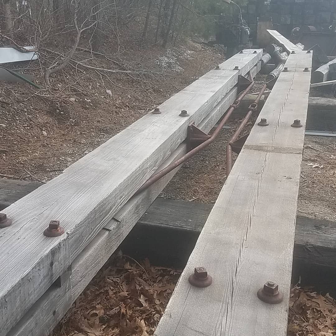 A couple of wooden boards with rusty screws attached to them.