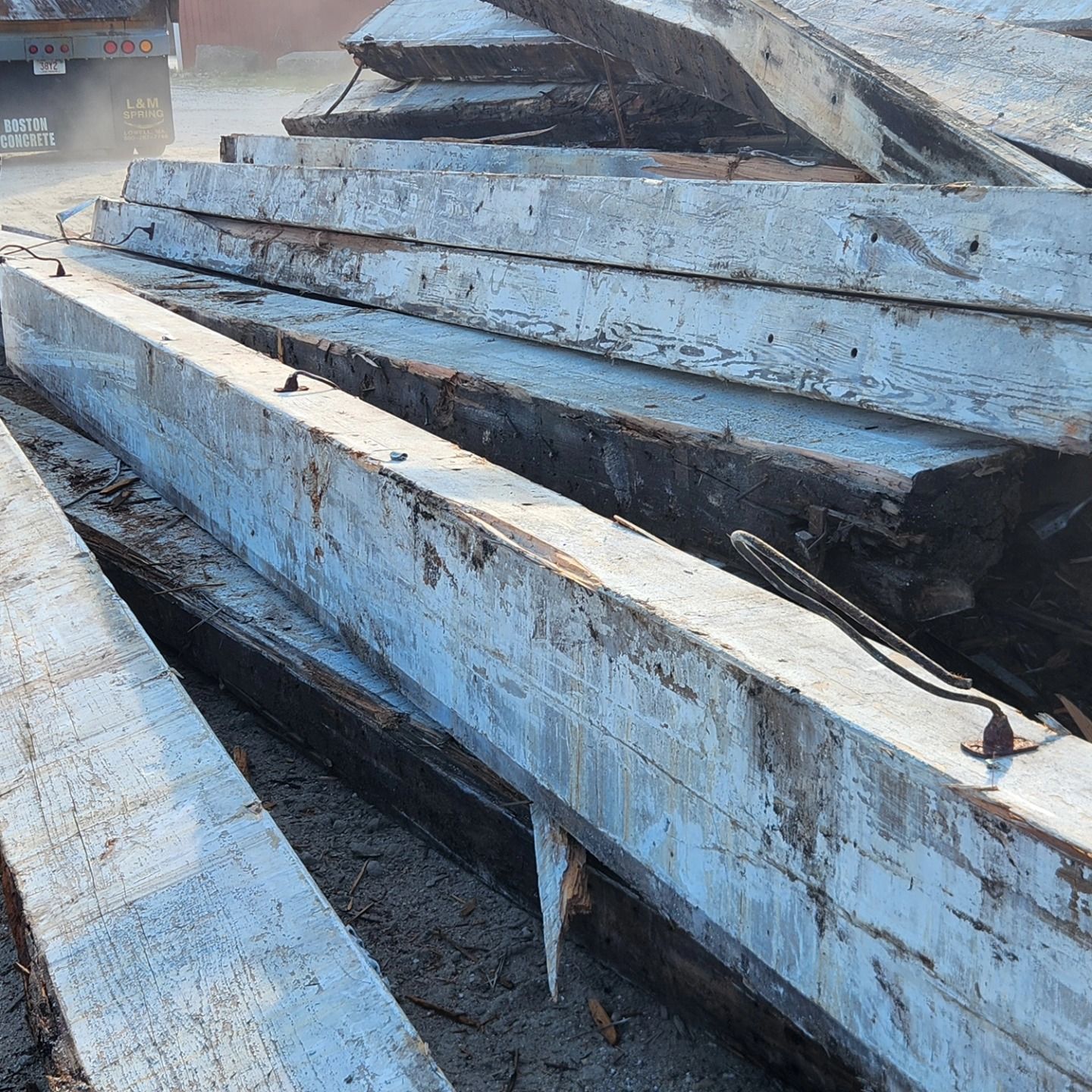 A pile of wooden beams are stacked on top of each other