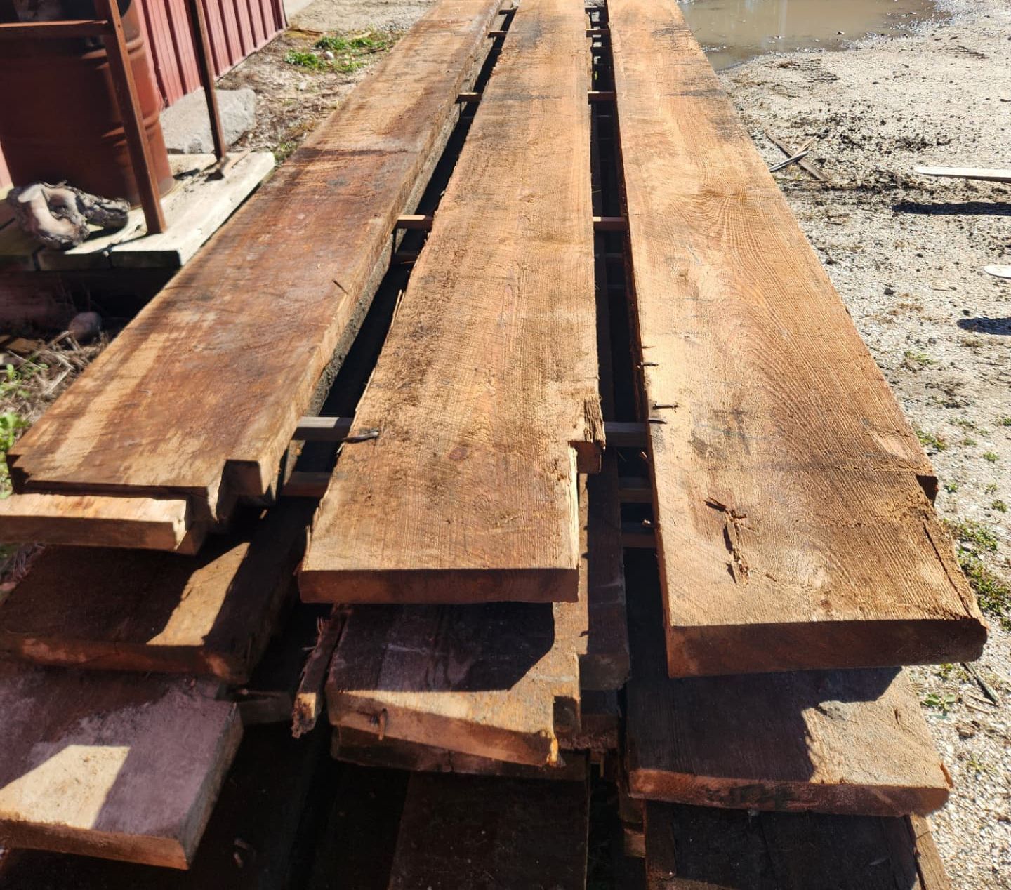 A bunch of wooden boards are stacked on top of each other
