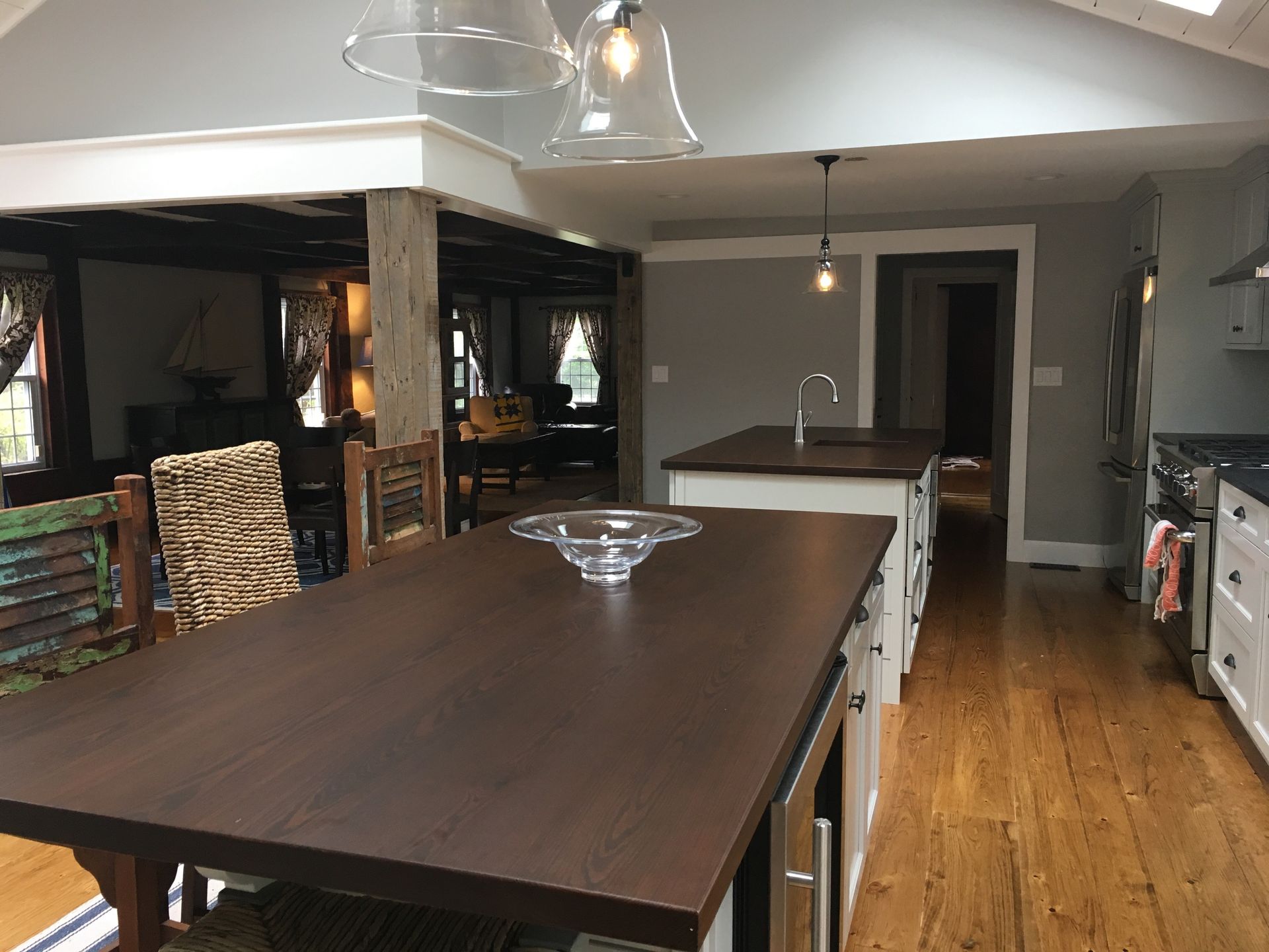 A kitchen with a table and chairs and a large island in the middle.