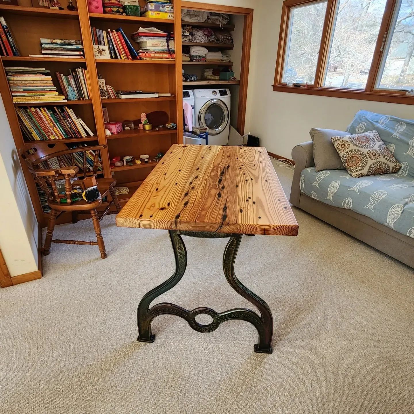 A wooden table in a living room next to a couch