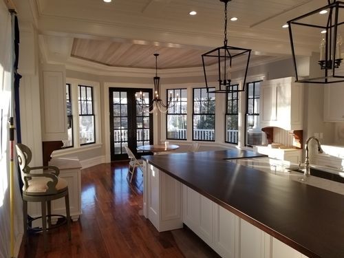 A kitchen with a large island and lots of windows