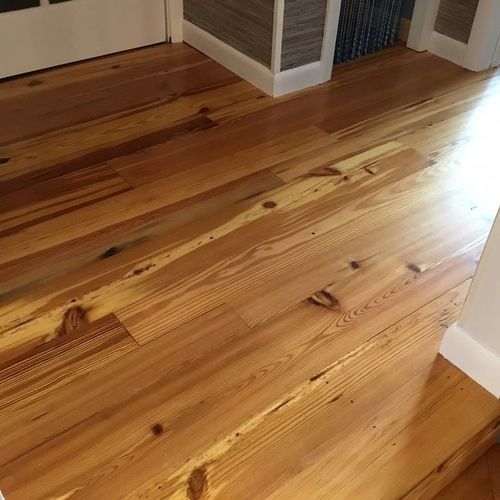 A close up of a wooden floor in a room.