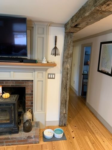 A living room with a fireplace and a flat screen tv