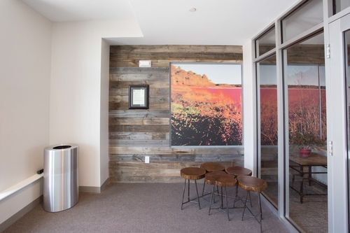 A room with a picture on the wall and a trash can