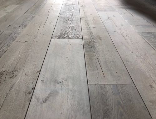A close up of a wooden floor in a room.