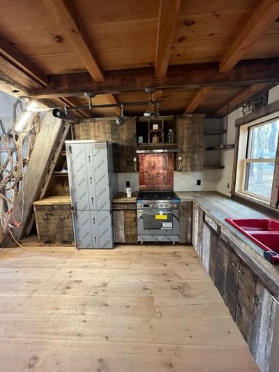 A kitchen with stainless steel appliances and wooden cabinets.