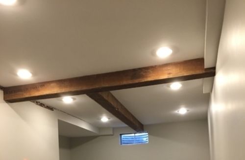 A hallway with a wooden beam hanging from the ceiling.
