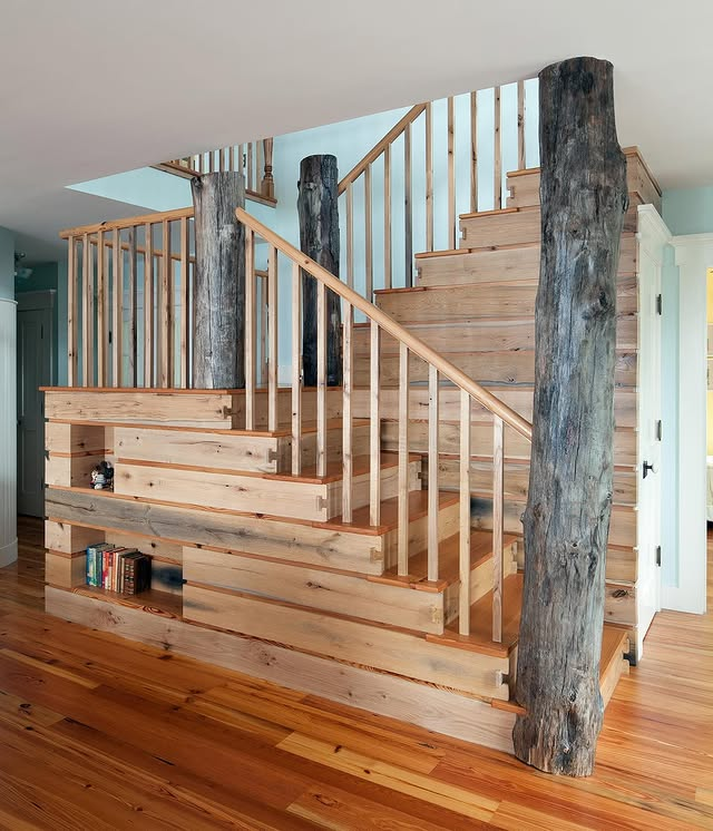 A room with a lot of windows and a wooden floor