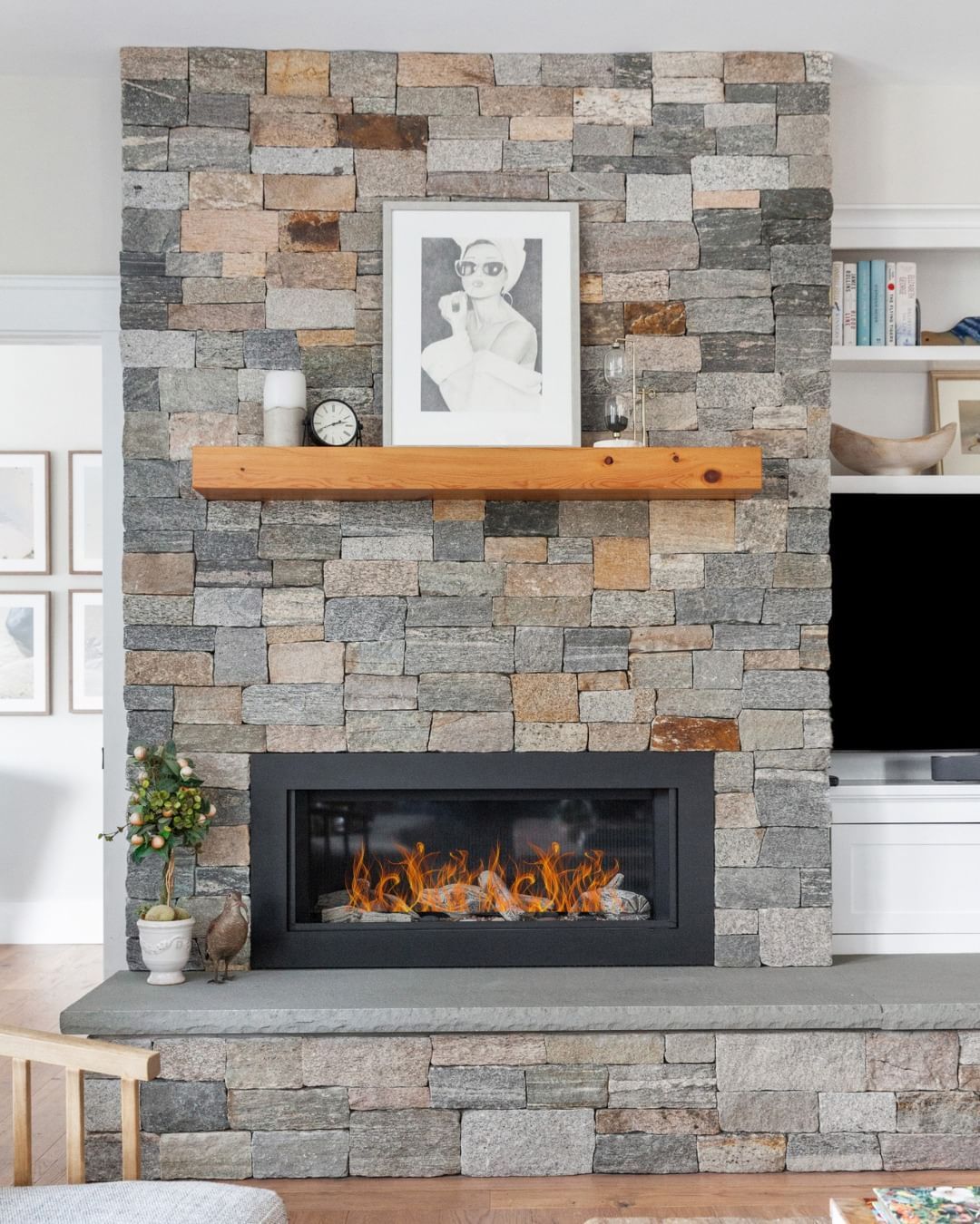 A living room with a fireplace and a flat screen tv above it.