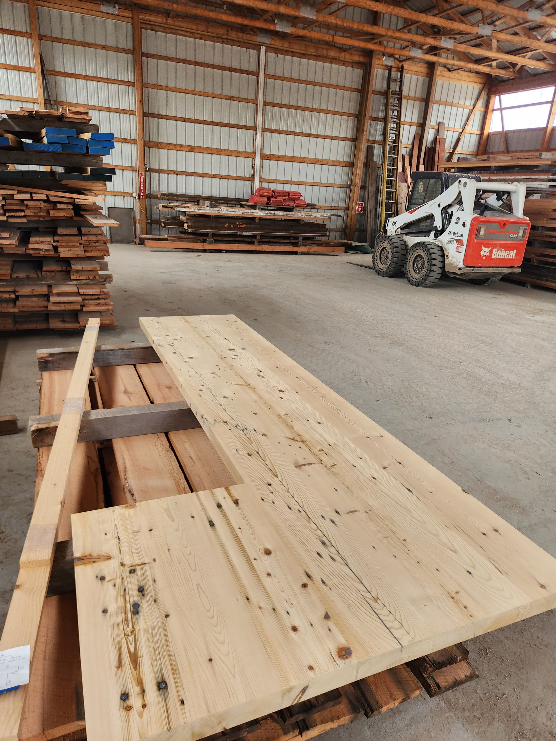 A kitchen with a long wooden counter top and chairs.