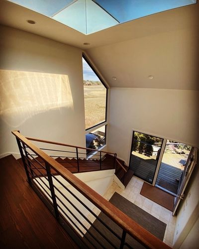 A staircase in a house with a skylight above it